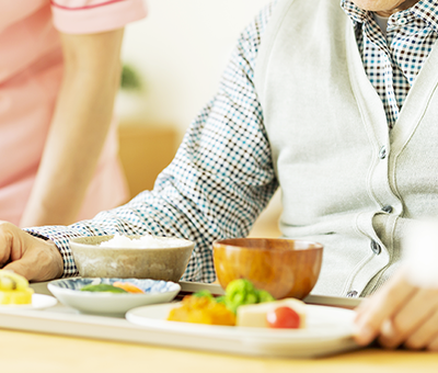 食卓に着いた高齢男性の画像