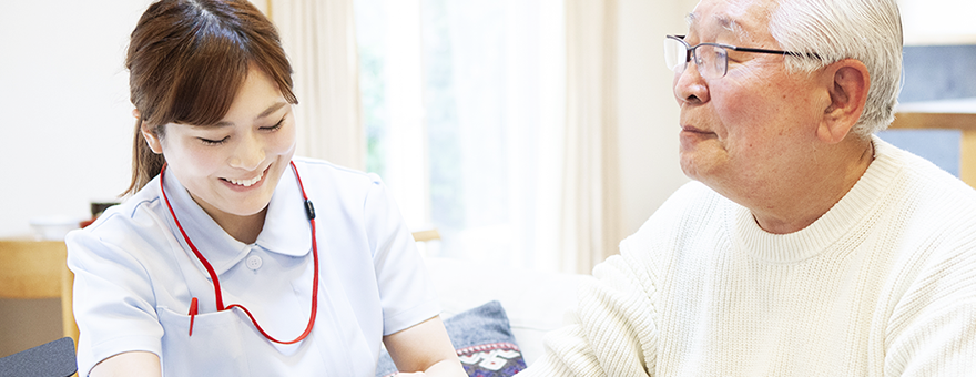 Image of a female nurse treating an elderly man